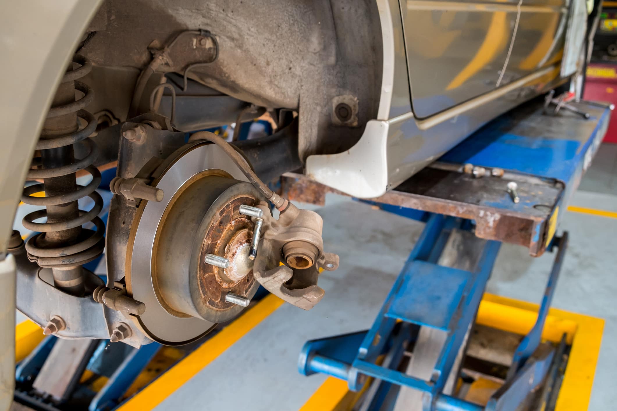 Disc brake of the car during the maintenance at auto service, closeup rear disc brake of the vehicle for repair.