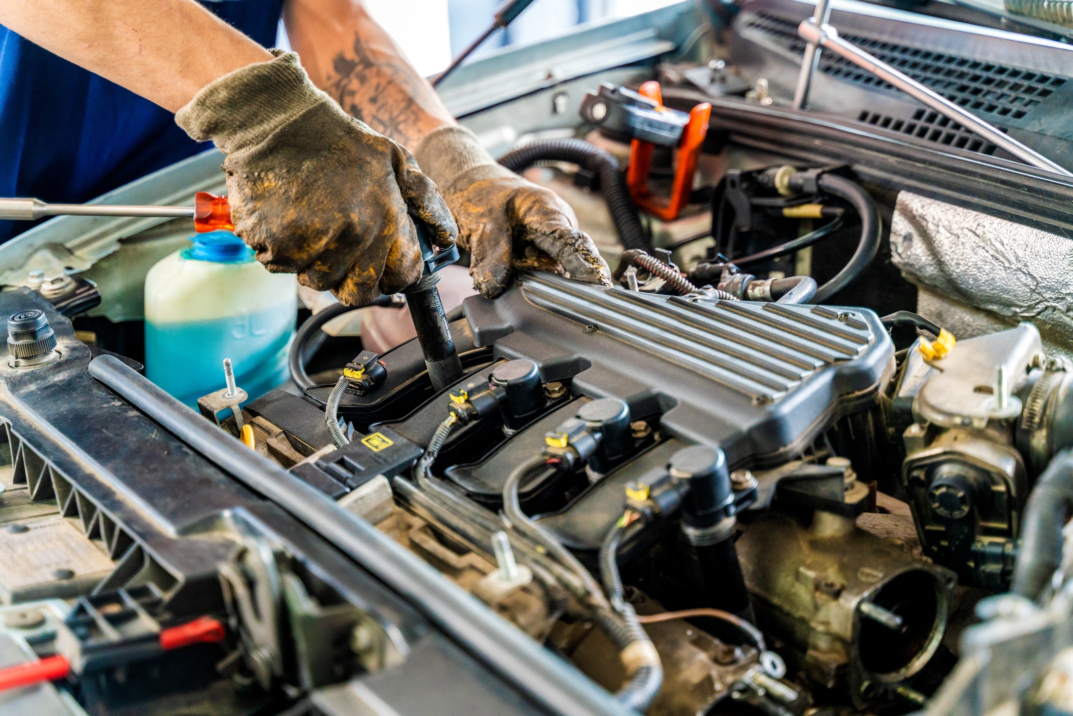 Professional mechanic working on the engine of the car in the garage